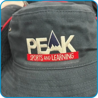 A gray hat with PEAK Sports and Learning embroidered on the front.