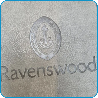 Ravenswood logo and crest embossed on textured grey material.