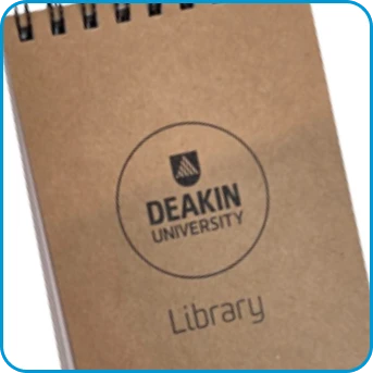 Brown spiral notebook with Deakin University Library logo on the cover.