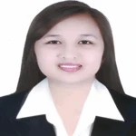 Woman in a black blazer smiling at the camera on a white background.